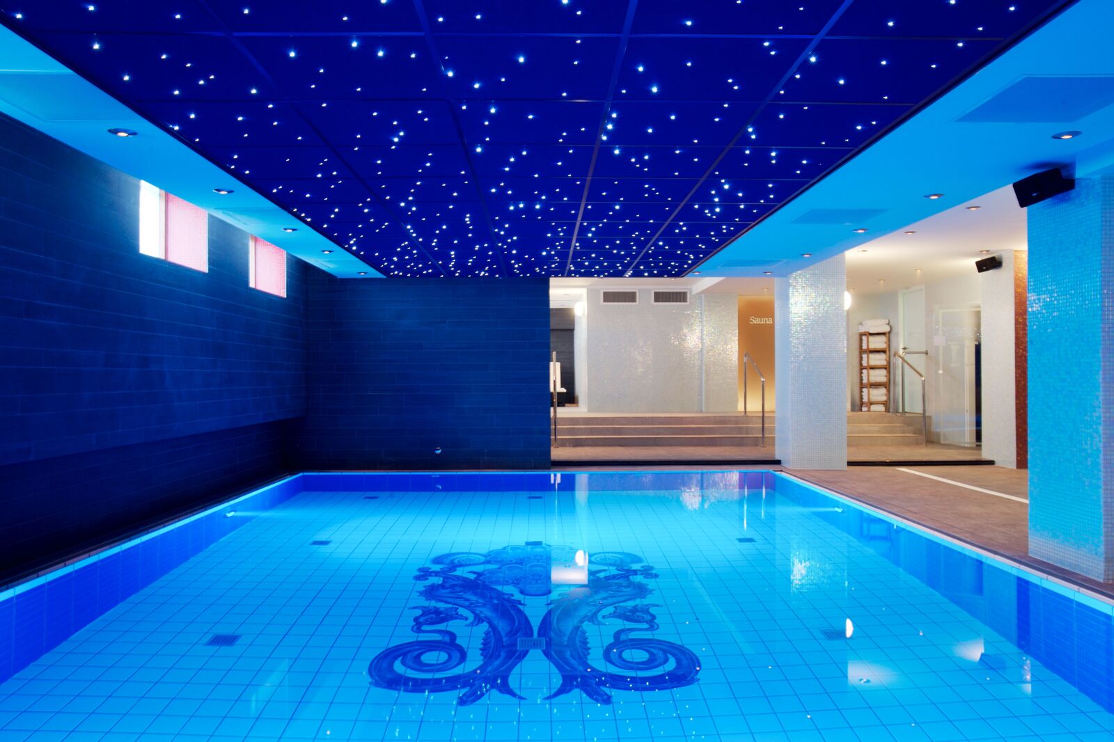 Indoor pool with mosaic tiles and a starry ceiling in the wellness area of Grand Hotel Amrâth Amsterdam.