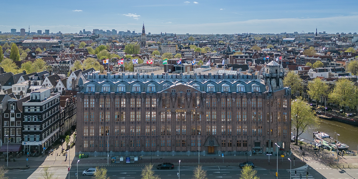 Grand Hotel Amrâth Amsterdam with a city panorama in the background.