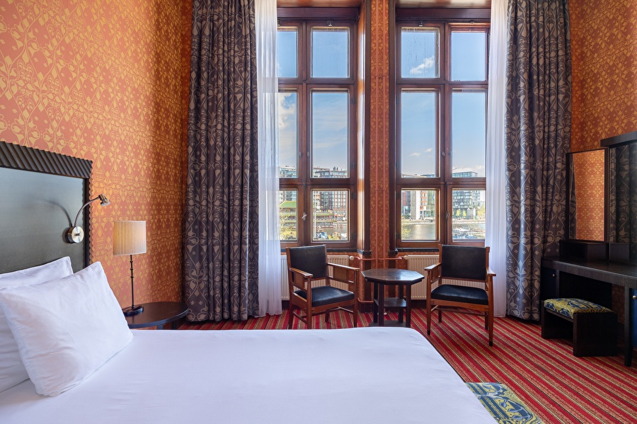 Seating area of the Superior Deluxe room with a view of the water and modern decor.