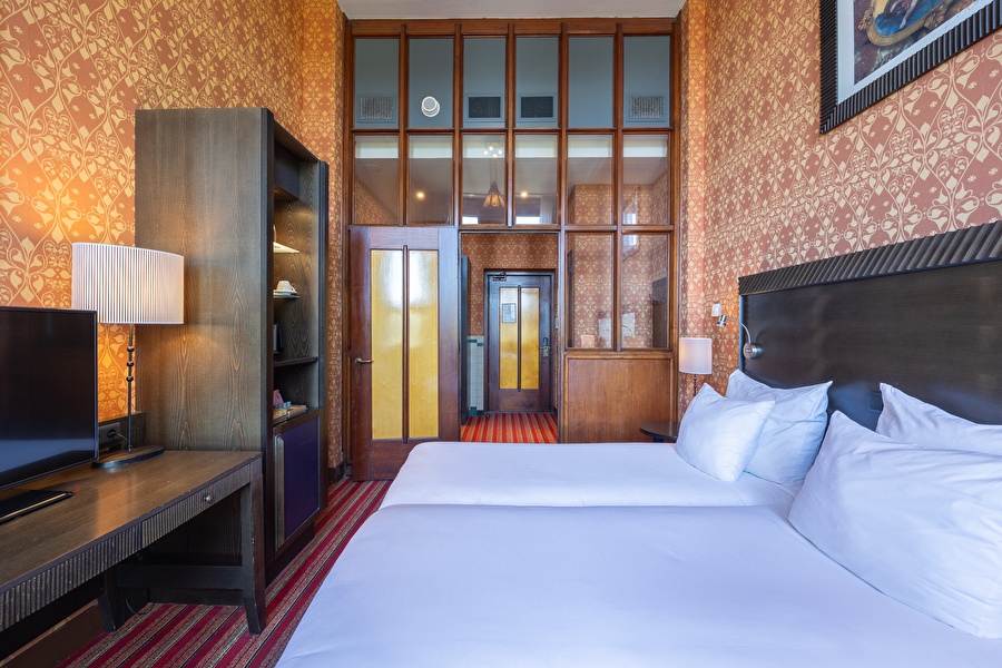Superior Deluxe room in Grand Hotel Amrâth Amsterdam with art nouveau details, high ceilings, and a warm interior.
